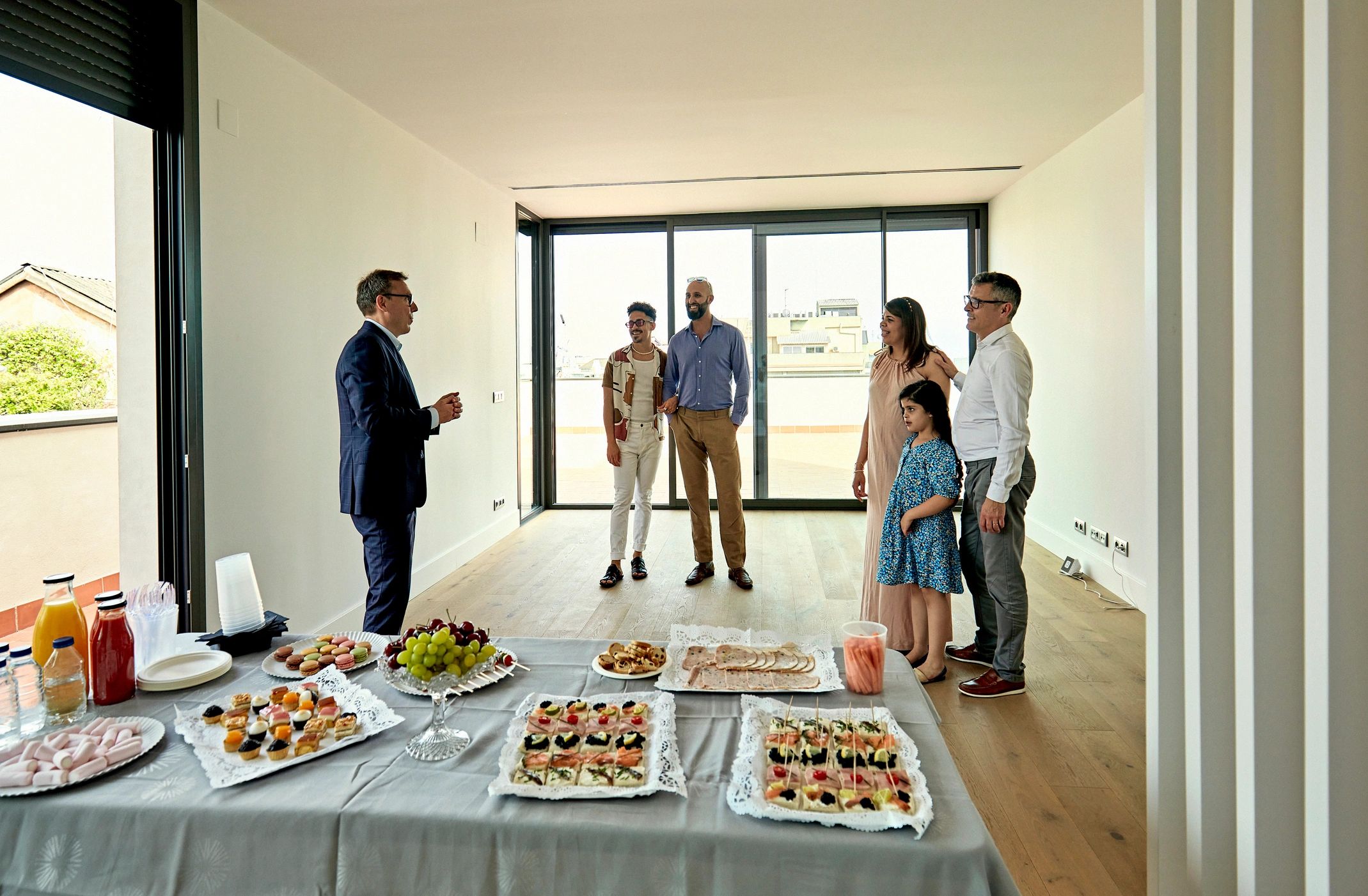 Real estate agent speaking with prospective buyers at an open house