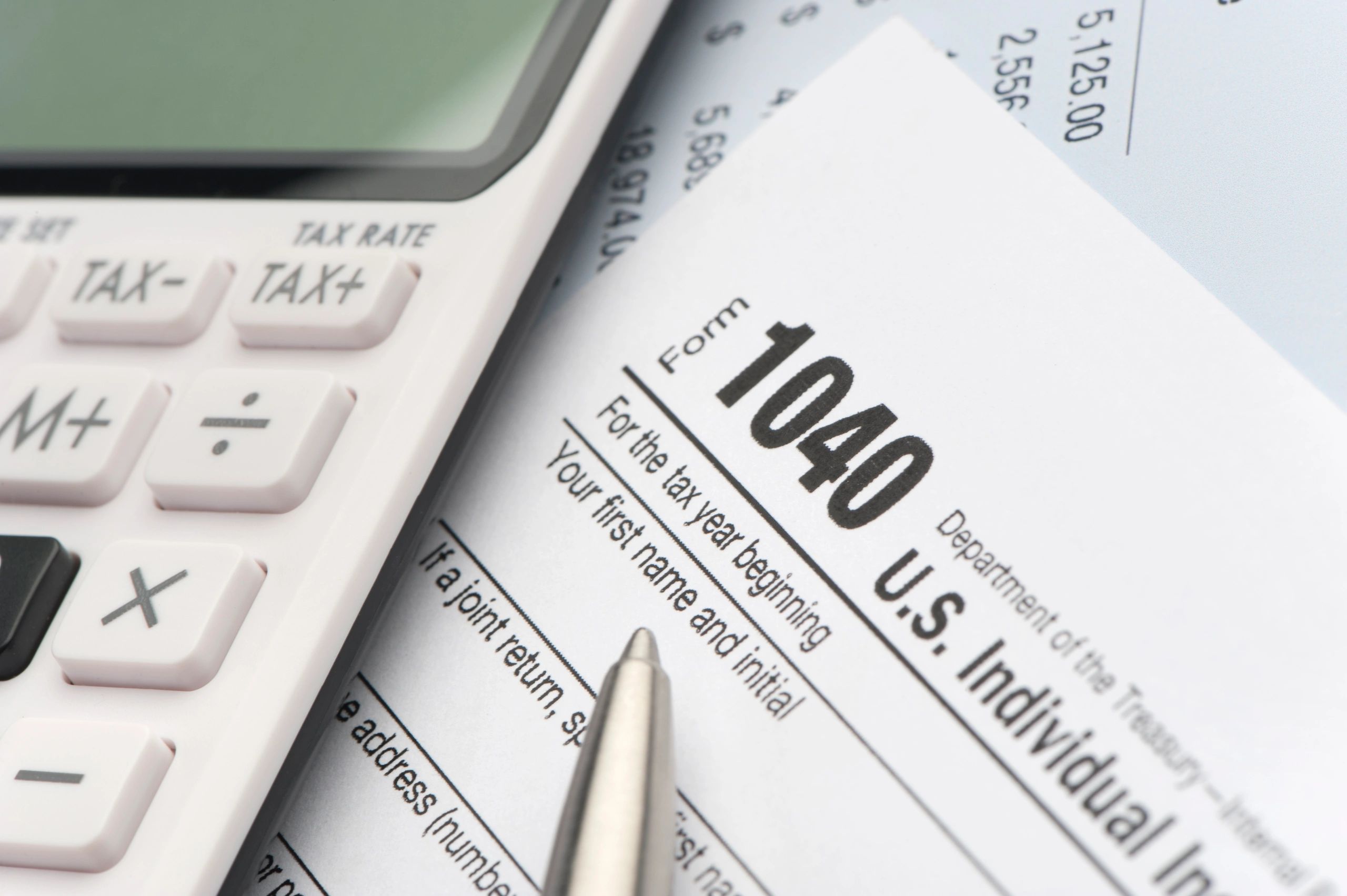 Tax return form and calculator on desk