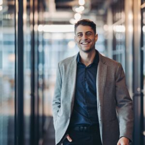 Smiling young man in walking confidently towards the camera